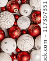 Red and white Christmas baubles close up full frame flat lay. Merry Christmas and Happy New Year seasons greetings card. Copy space. 117307351