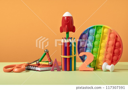 Group of colored stationery. rocket pencils on yellow background with rocket. Brain teaser and development for back to school or education. Bright accessories. Success achievement ideas Group of colored stationery. rocket pencils on yellow background with rocket. Brain teaser and development for back to school or education. Bright accessories. Success achievement ideas 117307391