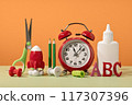 Group of colored stationery. rocket pencils and alarm clock on yellow background with rocket. back to school or education. Bright accessories. Success achievement. letters ABC 117307396