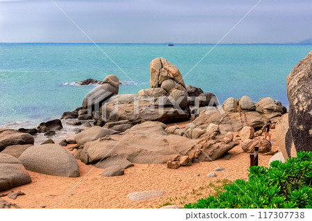 View of large rocks along the shore of the South China Sea. Sky Grottoes Park, Sanya, China 117307738