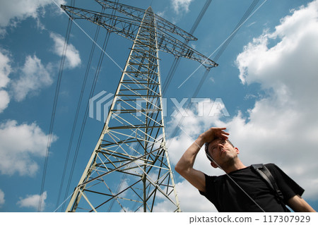 man looks distance high voltage tower line 117307929