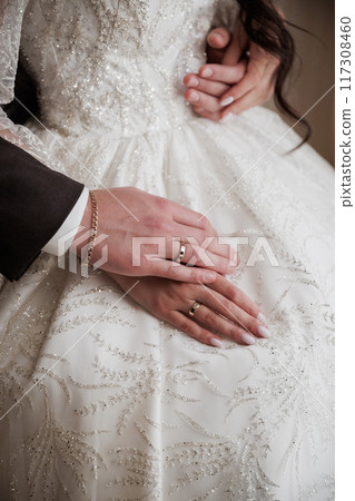 Bride and groom with bands holding hands and touching during their wedding ceremony Bride and groom with bands holding hands and touching during their wedding ceremony 117308460