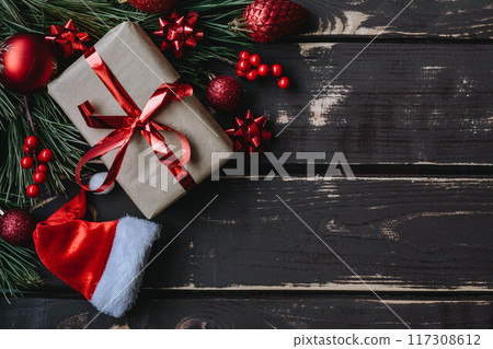 Christmass background gift boxe,red christmas tree toys,Santa hatn and spruce brance on wooden background. Christmass background gift boxe,red christmas tree toys,Santa hatn and spruce brance on wooden background. 117308612