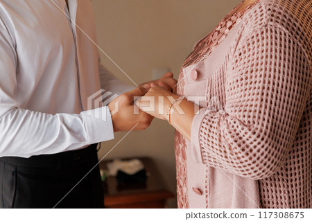 Heartwarming moment of mother and son holding hands, expressing love and support Heartwarming moment of mother and son holding hands, expressing love and support 117308675