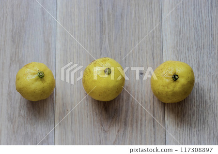 Yellow lemons on a wooden table 117308897