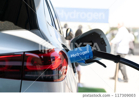 Close up of fuel cell car with connected hydrogen fueling nozzle Close up of fuel cell car with connected hydrogen fueling nozzle 117309003