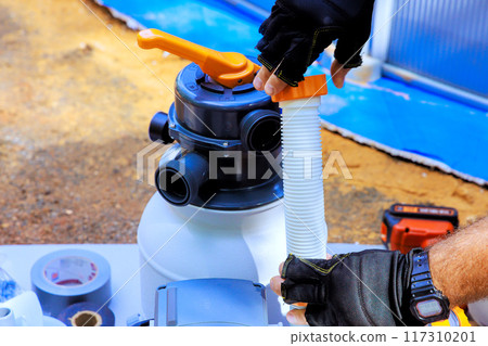 Maintenance worker assemble sand filter system tank equipment for cleaning swimming pools 117310201