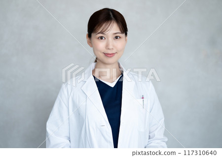 A female doctor in a white coat 117310640