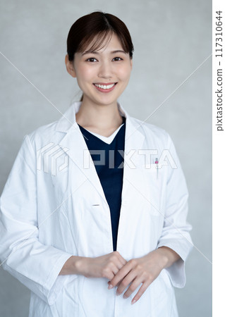 A female doctor in a white coat 117310644