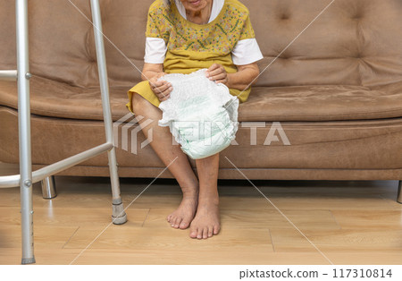 Urinary Incontinence in elderly and changing diaper. 117310814