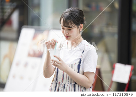 Young woman having a drink 117310879
