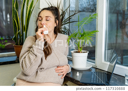 Pregnant Woman Using Nasal Spray at Home Pregnant Woman Using Nasal Spray at Home 117310888