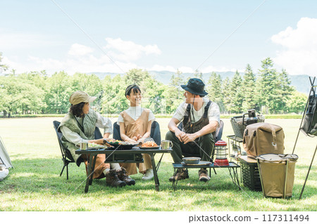 A friendly family enjoying day camping, camping and barbecues at a park or campsite A friendly family enjoying day camping, camping and barbecues at a park or campsite 117311494