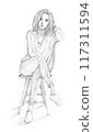 a young woman relaxing on a chair leaning on the backrest and resting her arm on her head with an neutral expression. 117311594