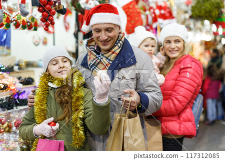 Man and teenage daughter choosing Christmas toys Man and teenage daughter choosing Christmas toys 117312085