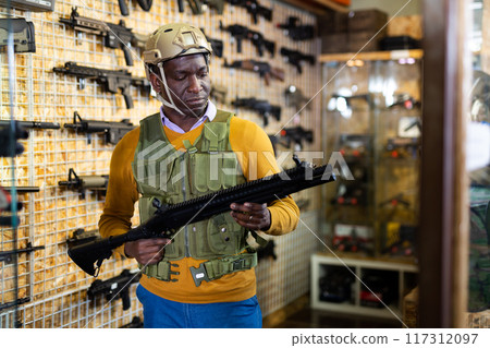 Man in armor choosing weapon in arms shop Man in armor choosing weapon in arms shop 117312097