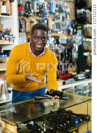 African american gunsmith demonstrating rifle scope for sale African american gunsmith demonstrating rifle scope for sale 117312113