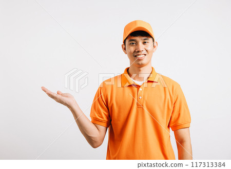 Portrait Asian smiling young delivery man showing something with empty open palm hands studio isolated white background, Happy lifestyle men carry person in an orange shirt uniform Portrait Asian smiling young delivery man showing something with empty open palm hands studio isolated white background, Happy lifestyle men carry person in an orange shirt uniform 117313384