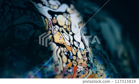Acid ink. Bubble liquid. Defocused blue yellow color fizzy texture chemical fluid wave on dark black abstract art background. 117313819