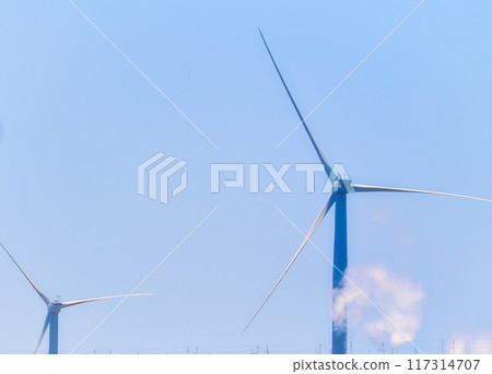 Scenery of wind turbines generating electricity under clear blue skies Scenery of wind turbines generating electricity under clear blue skies 117314707