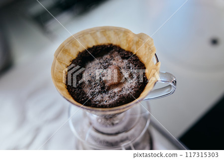 Pour hot water into the dripper Pour hot water into the dripper 117315303