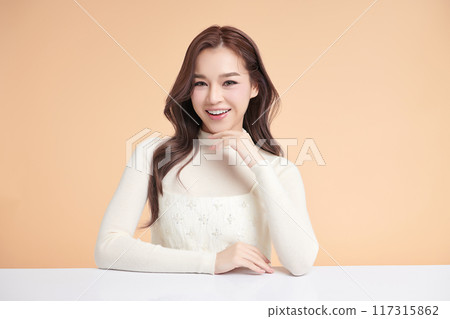 Beautiful young asian woman with clean fresh skin on beige background, Face care, Facial treatment, Cosmetology, beauty and spa, Asian women portrait. 117315862