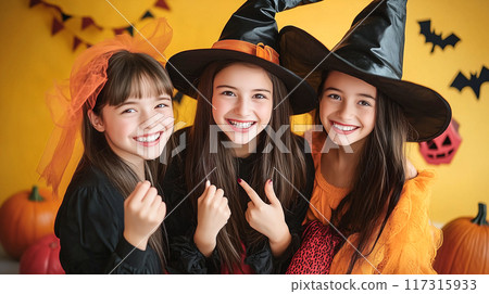 Three women dressed in Halloween costumes 117315933