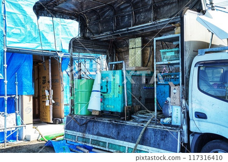 A scene with a truck making insulation for homes 117316410