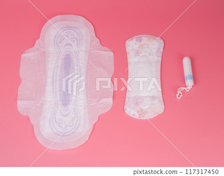 cotton medical towel or pad for women critical days on pink background. Care and protection. cotton medical towel or pad for women critical days on pink background. Care and protection. 117317450