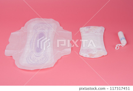 cotton medical towel or pad for women critical days on pink background. Care and protection. 117317451