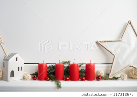 New year and Christmas preparation. Four red advent candles in white windowsill. Handmade eco-friendly decor. Sustainable Christmas decoration New year and Christmas preparation. Four red advent candles in white windowsill. Handmade eco-friendly decor. Sustainable Christmas decoration 117318673