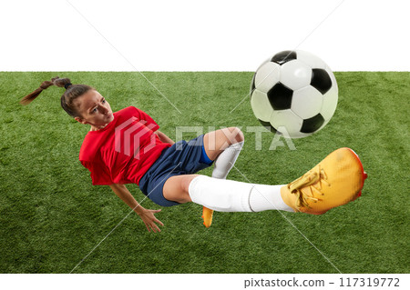 Female soccer player mid-air, executing bicycle kick with precision and power, showcasing athleticism and skill. 117319772