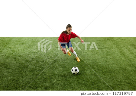 Competitive young woman, soccer player running across football field, dribbling ball in motion against white background. Competitive young woman, soccer player running across football field, dribbling ball in motion against white background. 117319797