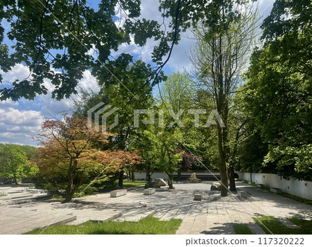 Garden with stone walkway and fountain in the park on sunny day at Chorzow, Poland 117320222