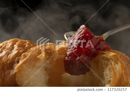 Croissant cross section Spooning jam on top 117320257