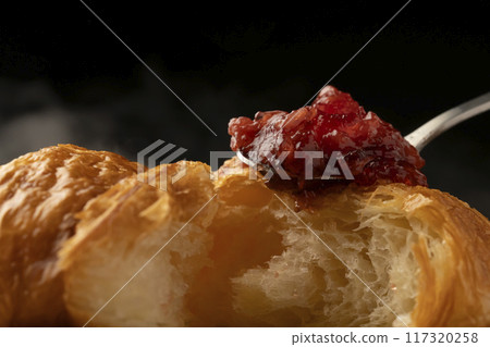 Croissant cross section Spooning jam on top 117320258