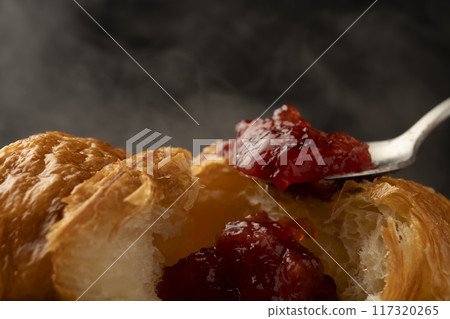 Croissant cross section Spooning jam on top Croissant cross section Spooning jam on top 117320265