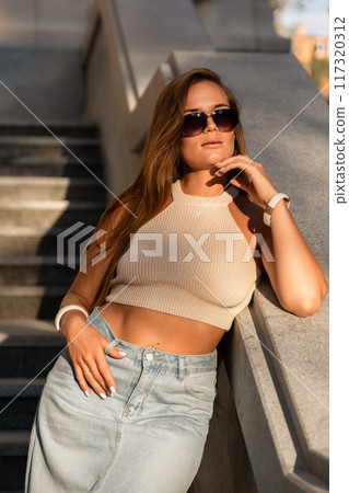 Woman Sunglasses Fashion Model Posing Outdoors on Stairs Woman Sunglasses Fashion Model Posing Outdoors on Stairs 117320312