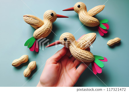 children's craft hummingbird made from peanuts, top view 117321472
