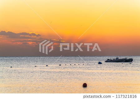 Beautiful yellow and orange sunrise over the sea. 117321816