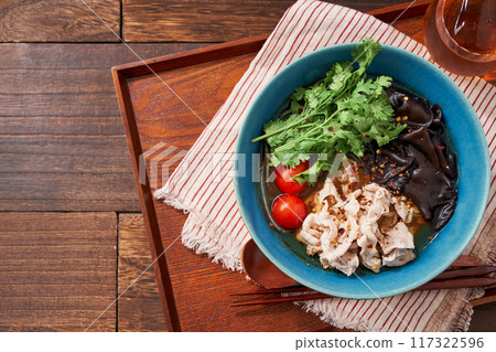 Malatang made with glass noodles topped with pork and wood ear mushrooms 117322596