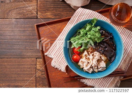 Malatang made with glass noodles topped with pork and wood ear mushrooms 117322597