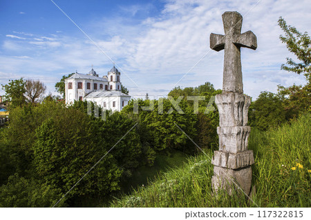 Ancient stone cross and the Church of the Assumption of the Blessed Virgin Mary (Carmelite Church). View from the Castle Hill. Mstislavl, Belarus Ancient stone cross and the Church of the Assumption of the Blessed Virgin Mary (Carmelite Church). View from the Castle Hill. Mstislavl, Belarus 117322815