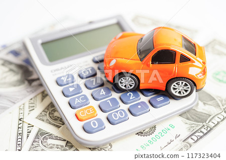 Bangkok, Thailand November 18, 2023 Car on banknote money with calculator, buying or insurance concept. Bangkok, Thailand November 18, 2023 Car on banknote money with calculator, buying or insurance concept. 117323404