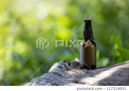 Brown Glass Spray Bottle on Tree Trunk. Copy Sapce. Brown Glass Spray Bottle on Tree Trunk. Copy Sapce. 117324003