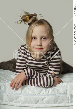 Smiling blonde child girl indoor portrait 117324022