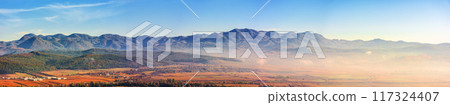 panorama of romania countryside in morning light. foggy weather. autumnal landscape in mountains. grassy field and rolling hills. rural scenery panorama of romania countryside in morning light. foggy weather. autumnal landscape in mountains. grassy field and rolling hills. rural scenery 117324407