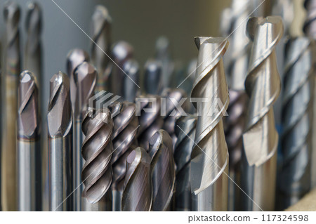 Close-up scene group of the used flat nose, bull nose and ball nose end mill tools. 117324598