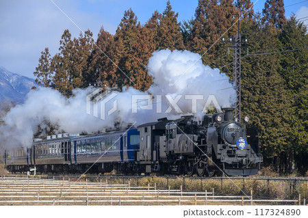 The SL Daiki steam locomotive runs, trailing smoke. 117324890