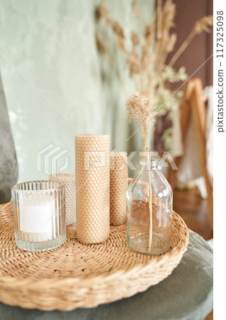 Woman hand holding candle at glass. Sunny day. Home bedroom interior Woman hand holding candle at glass. Sunny day. Home bedroom interior 117325098
